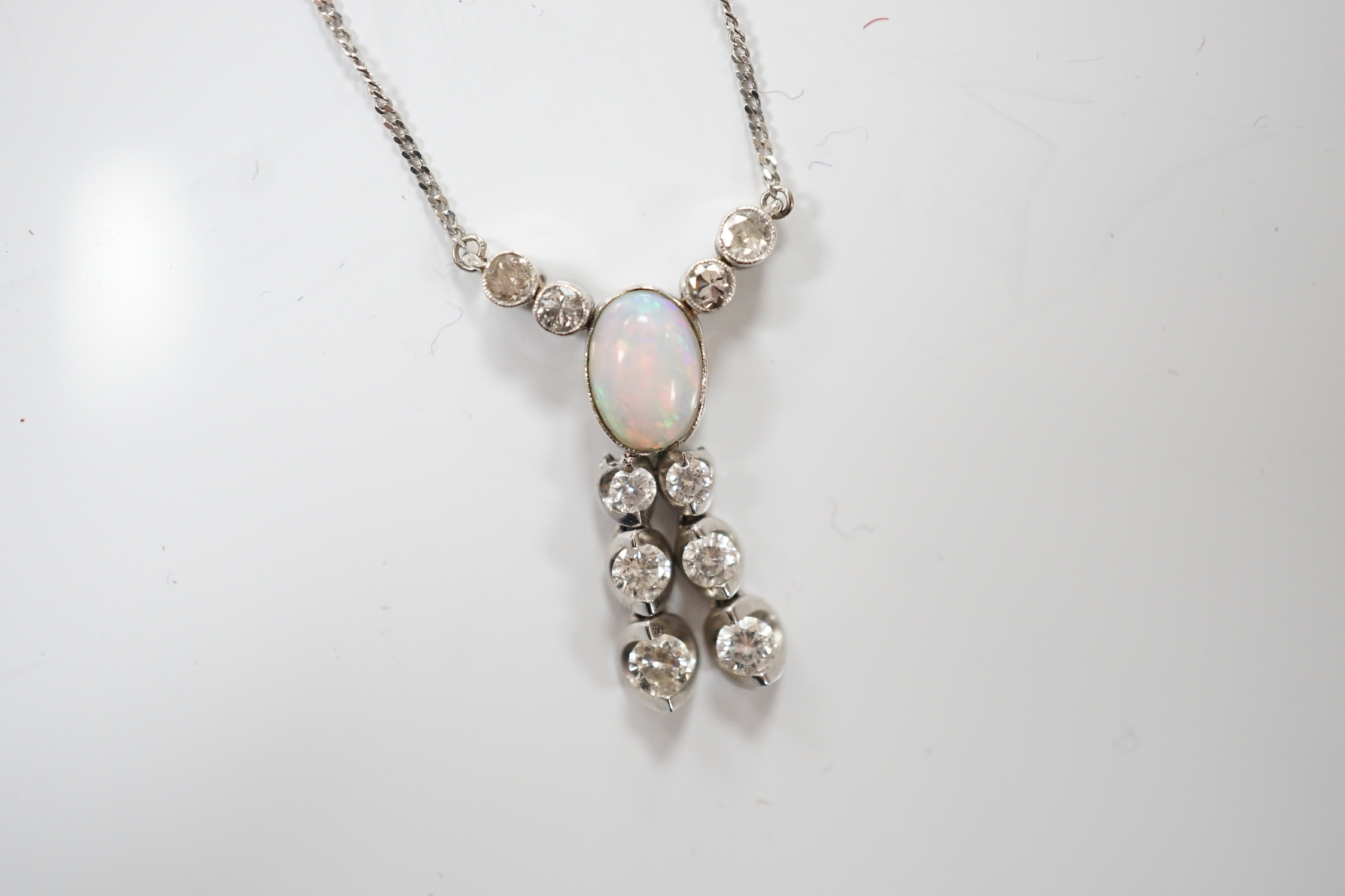 A modern 18ct white gold, white opal and diamond cluster set double drop pendant necklace, overall 56cm, gross weight 4.1 grams.
